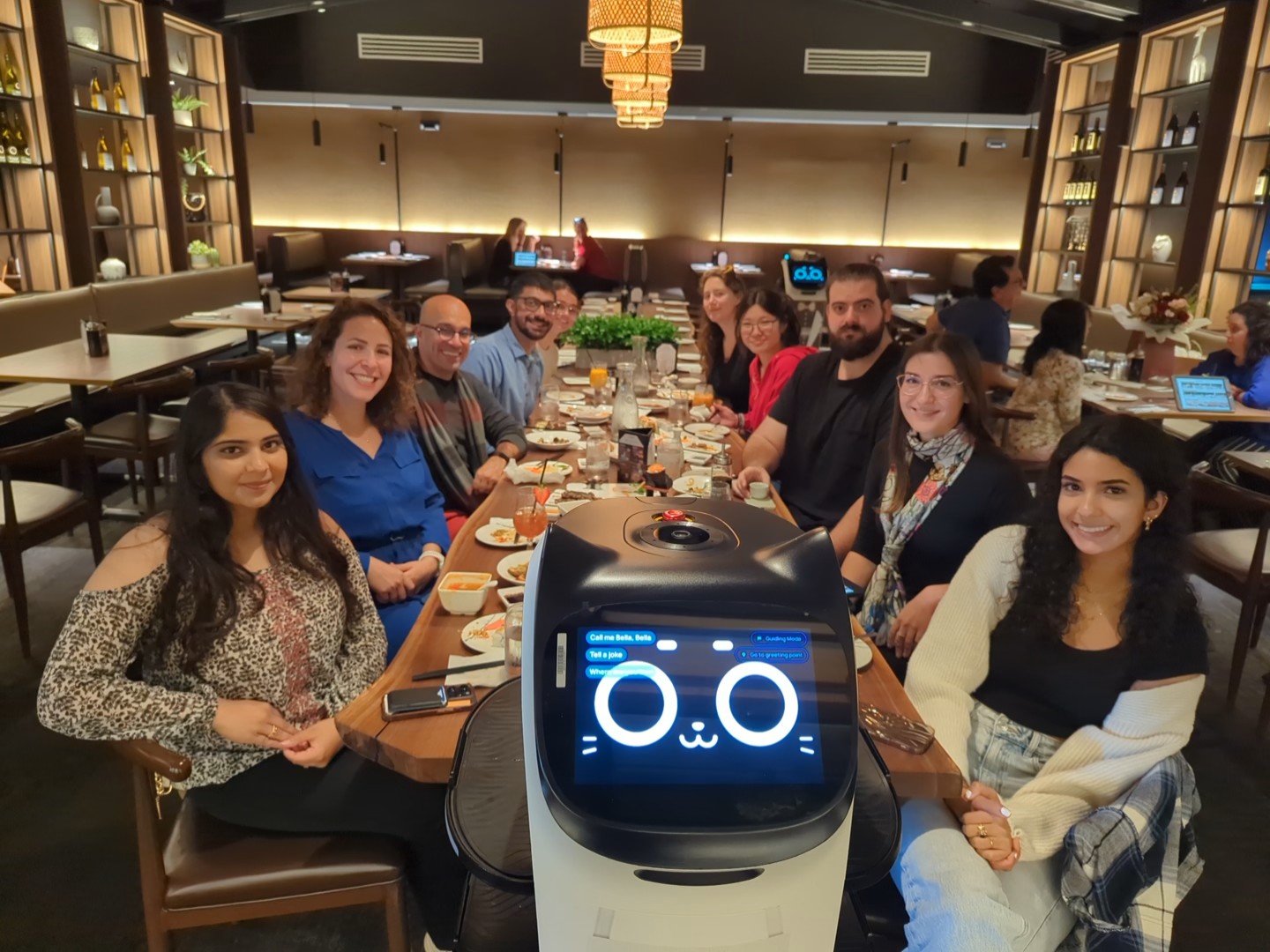 Gokcumen Lab members around a long table at a lab dinner