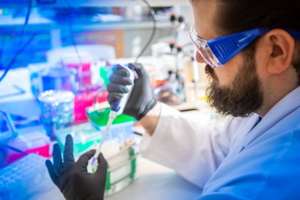 A lab member pipetting at the bench