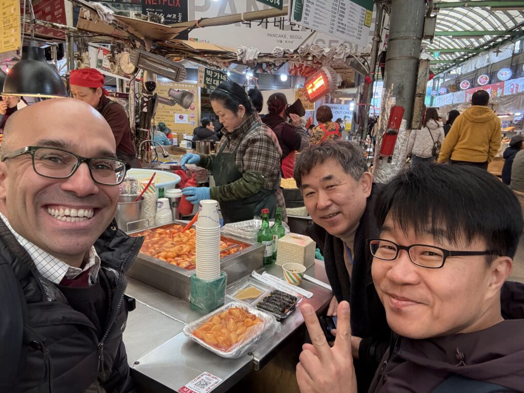 Omer Gokcumen with colleagues at a food market